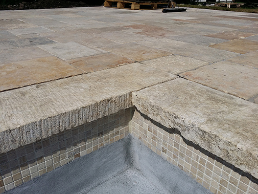 Antique Stone Pool Coping Slabs Milled at 2.5" in Thickness Installed in a pool in a Custom Home in Newport Beach
